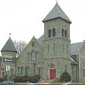 United Methodist Church, a gray stone building with a square tower and red door