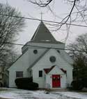 Saint Peter's Episcopal Church, a white building with red door and a cross on its pointed roof